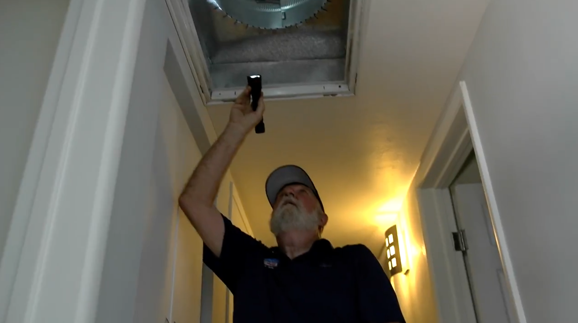 Inspecting air ducts for signs of mold.