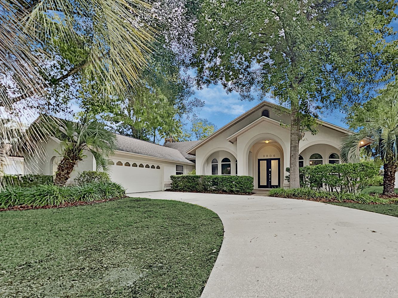 Front of home with driveway and two-care garage at Invitation Homes Tampa.