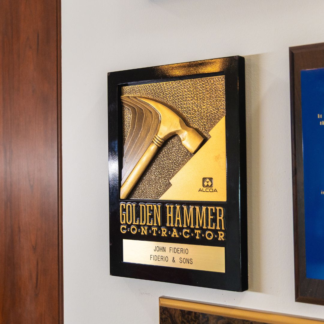John Fiderio’s prestigious “Golden Hammer Contractor” award, a symbol of remodeling excellence.