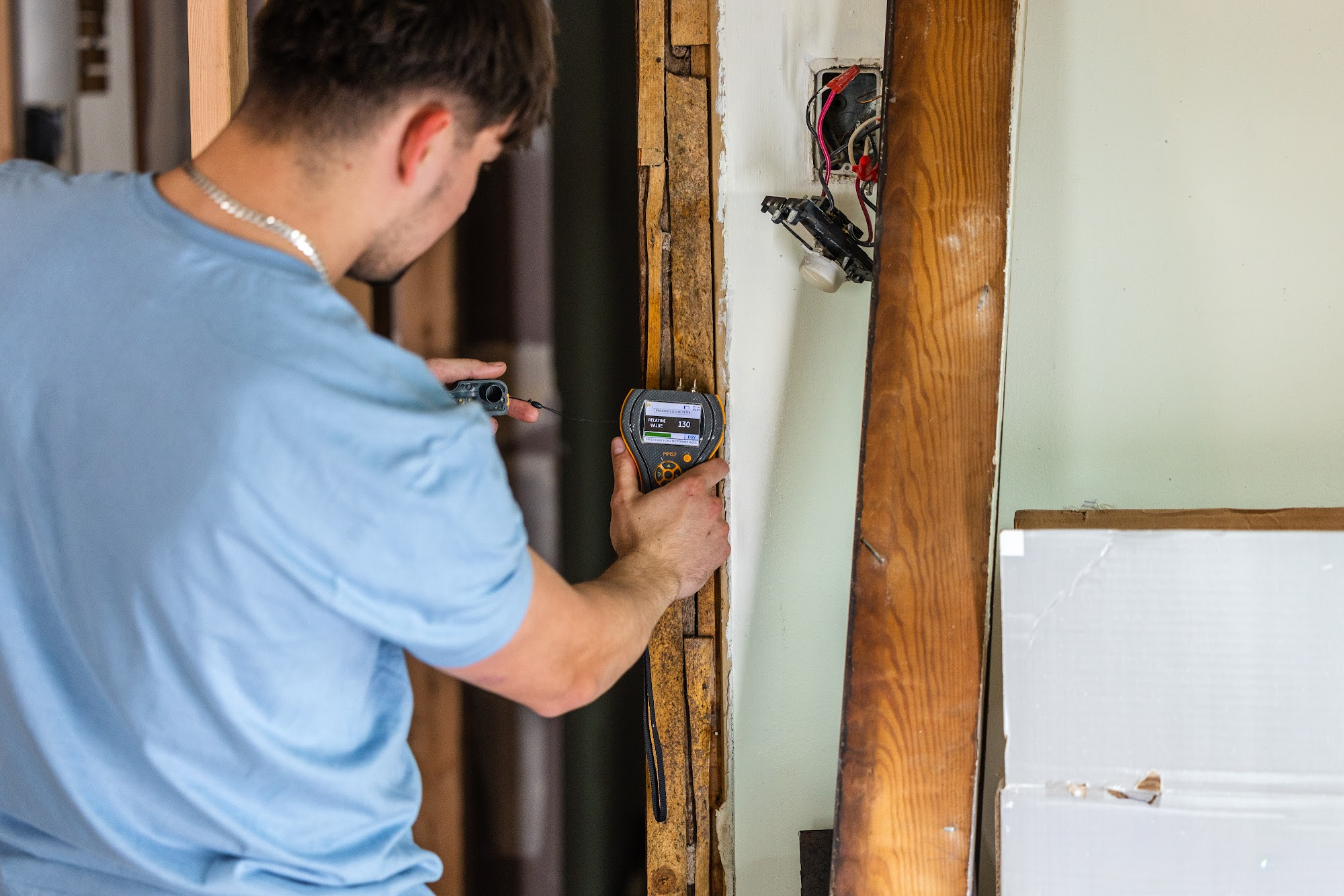 Taking moisture and humidity readings during a CT Mold Remediation Specialists inspection. 