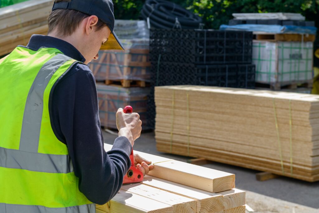 Image of man cutting timber