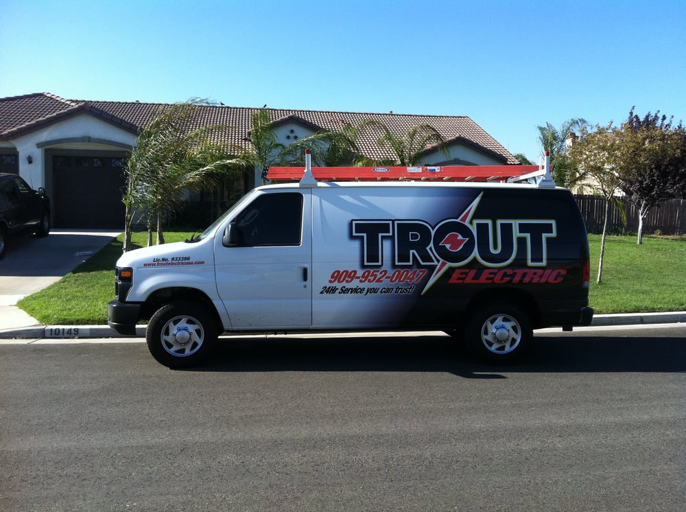 Trout Electric service van in front of a house