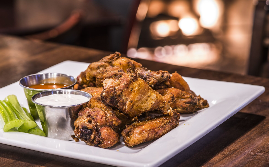 Traditional Wings: dry-rubbed with spice blend, choice of: Buffalo with blue cheese | Coca-Cola or Maker's Mark BBQ with ranch