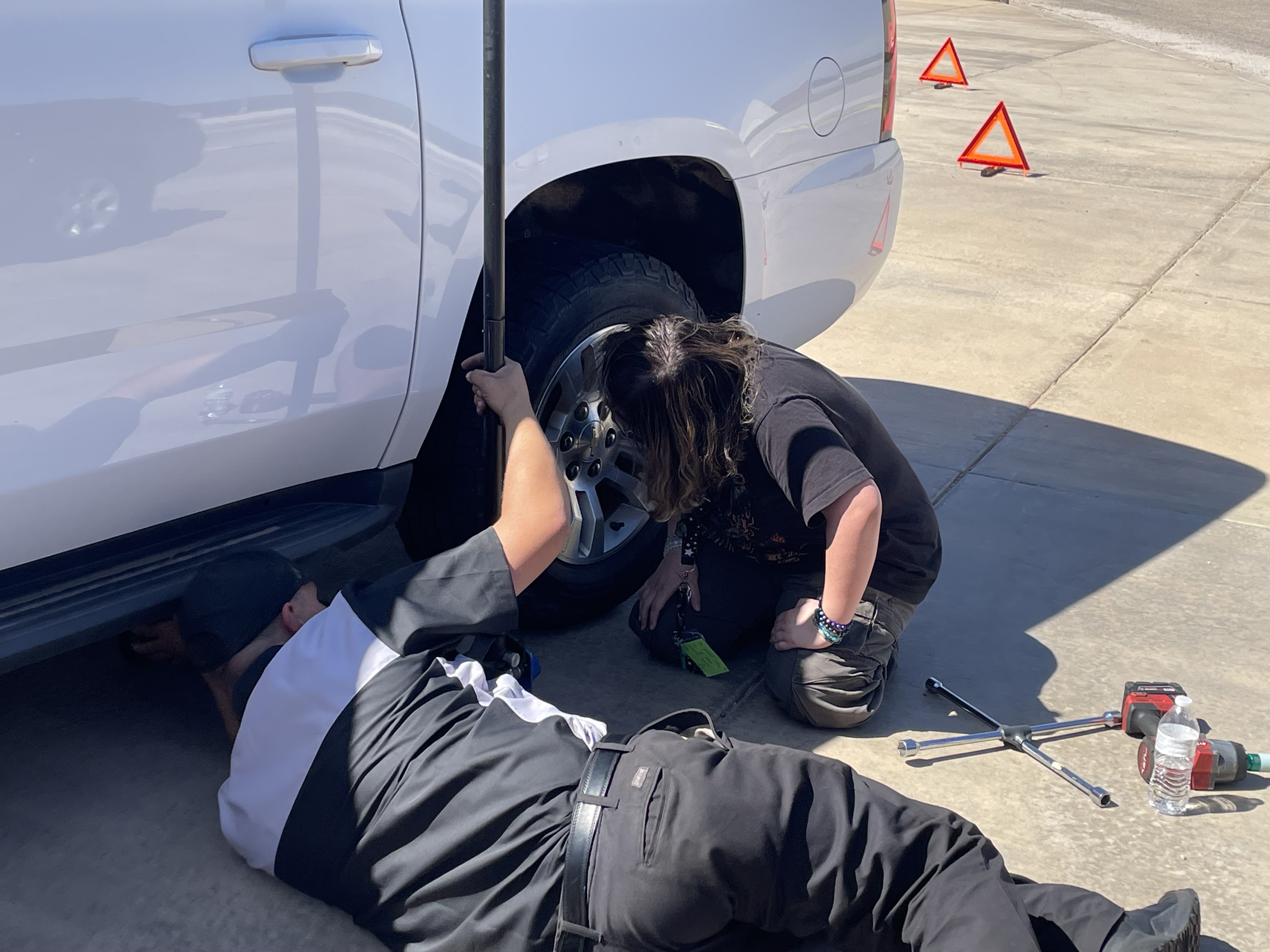 Our manager Billy teaching how to change a flat tire to students!