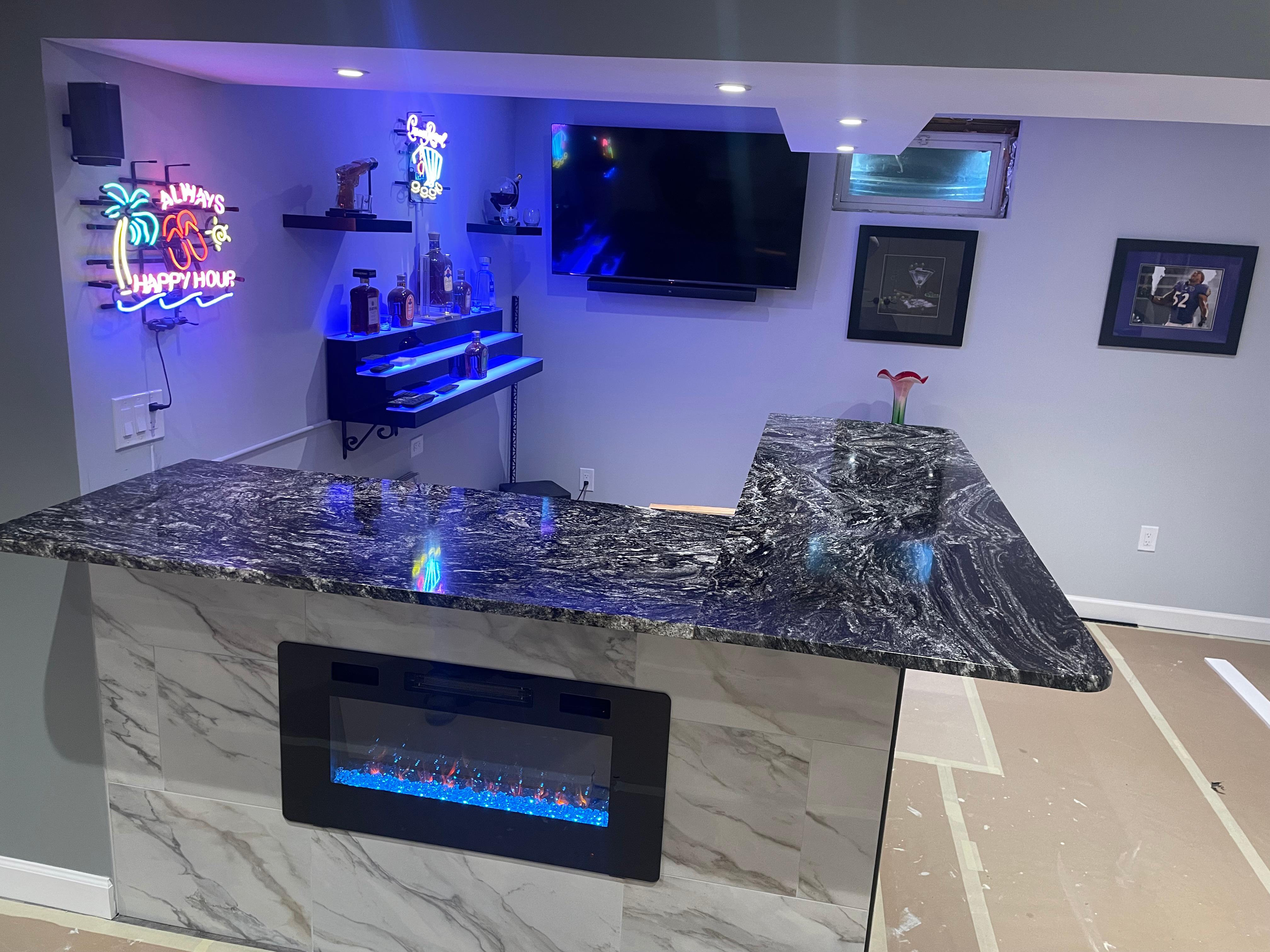 Home bar with new black granite countertops and built in fireplace.