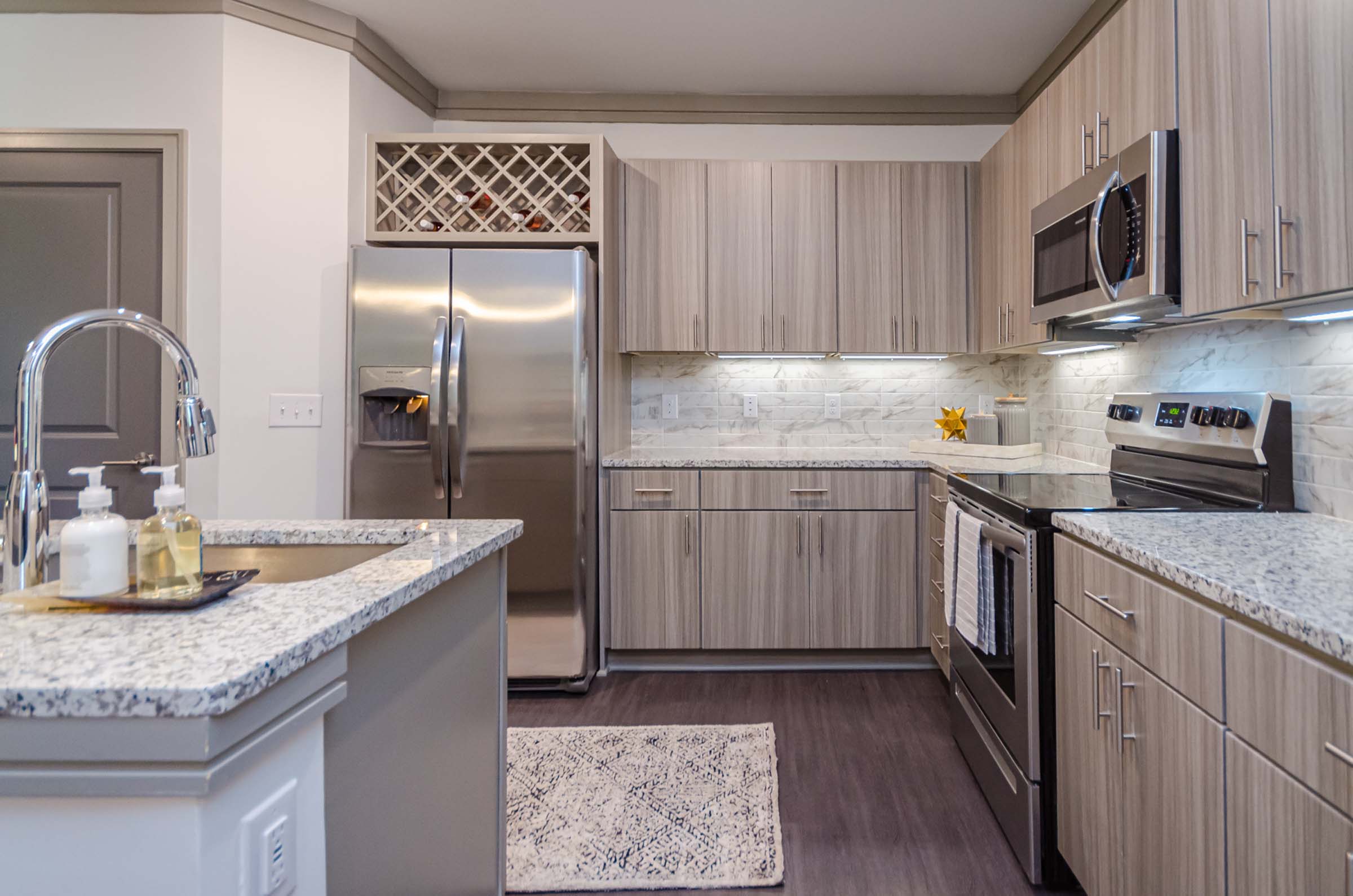 Kitchen with wine bottle storage in Camden Alpharetta apartments in Alpharetta, GA