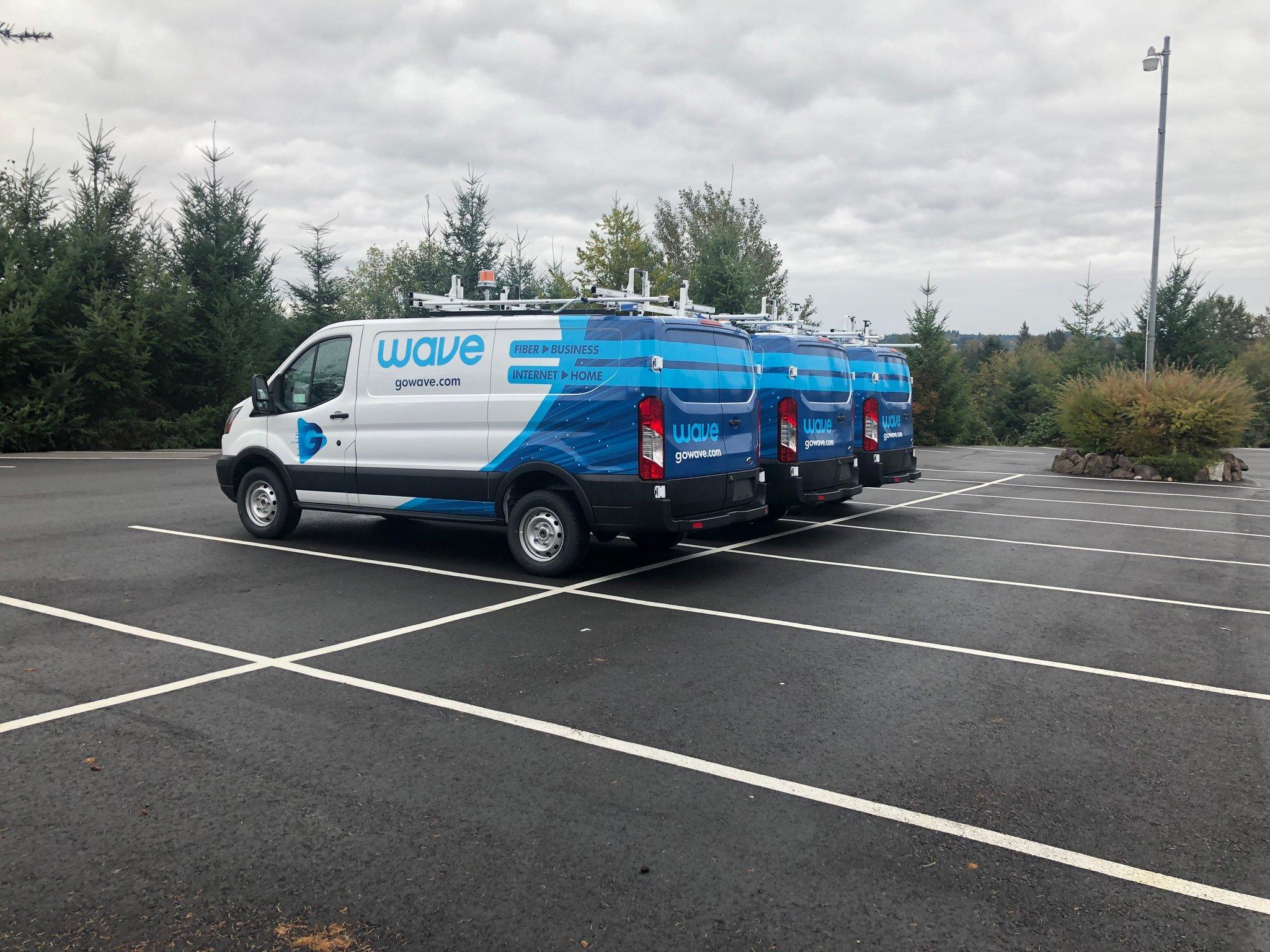 Matching partial wrap graphics on a fleet of Ford Transit vans for Wave, printed and installed by Ardor Printing.