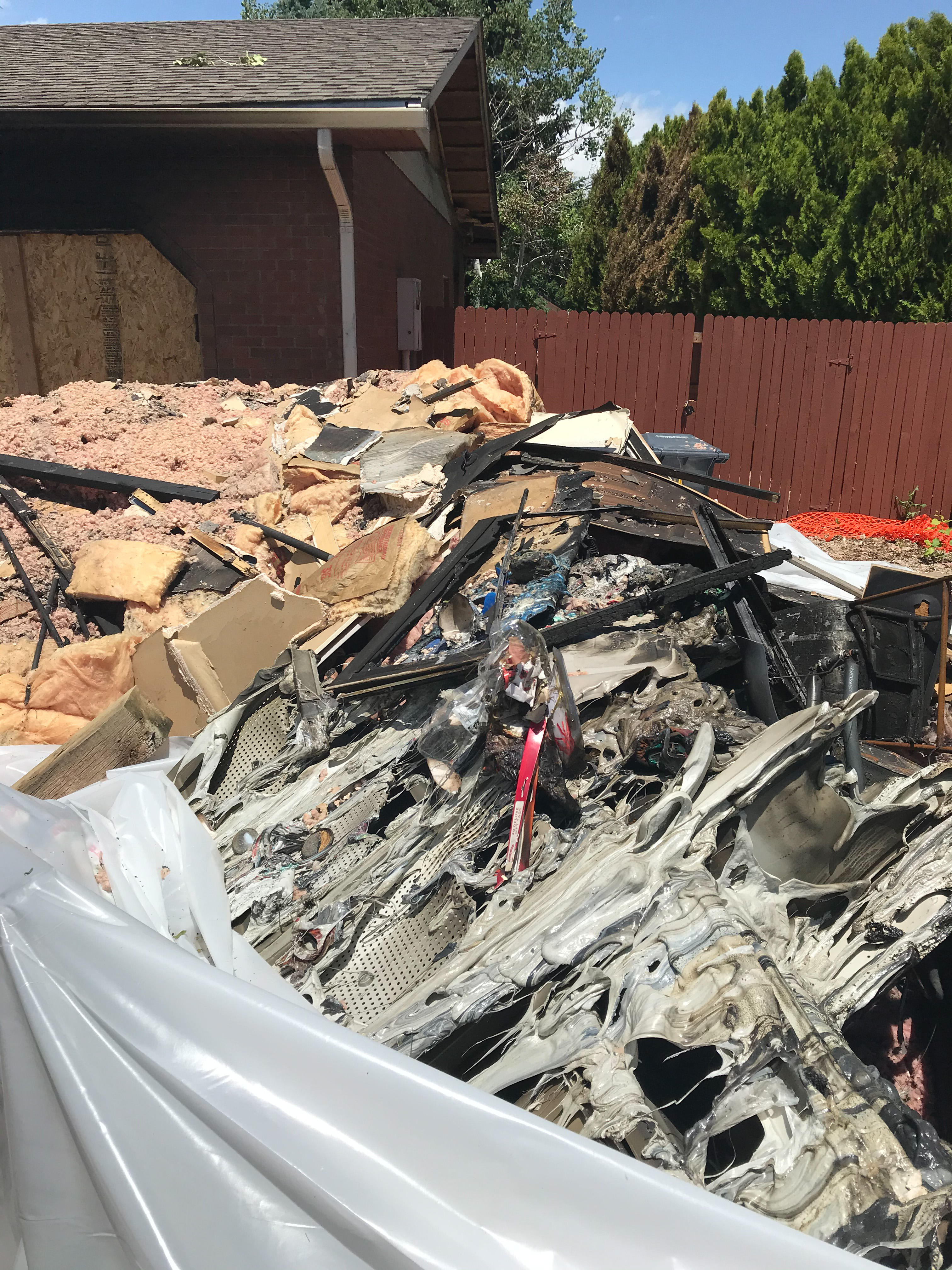 Piled up debris pulled outside after a house fire.