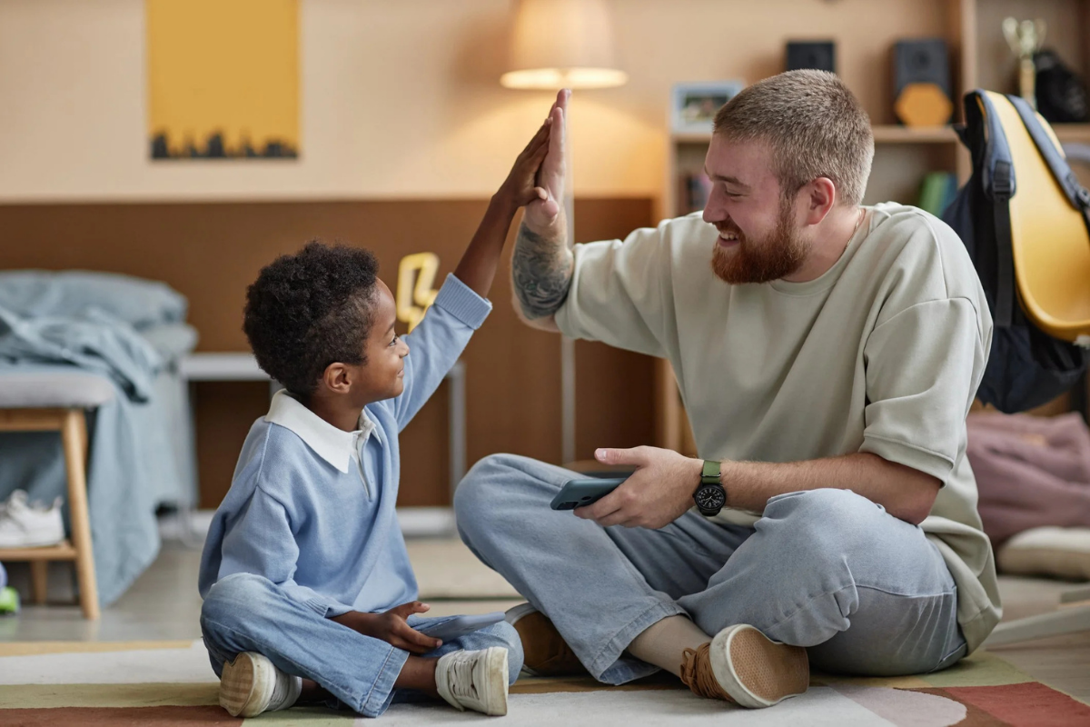 SAFY of Cincinnati adult giving child a high-five.