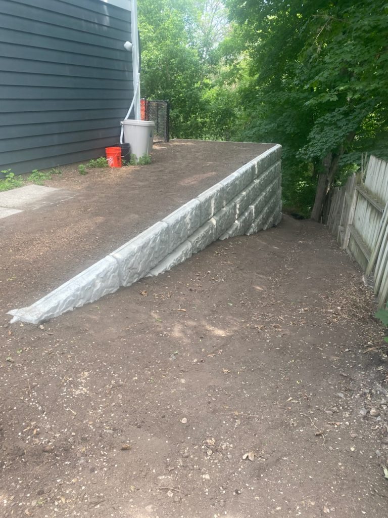 Clean, solid, and built to last. This concrete block retaining wall adds structure and definition to any outdoor space.