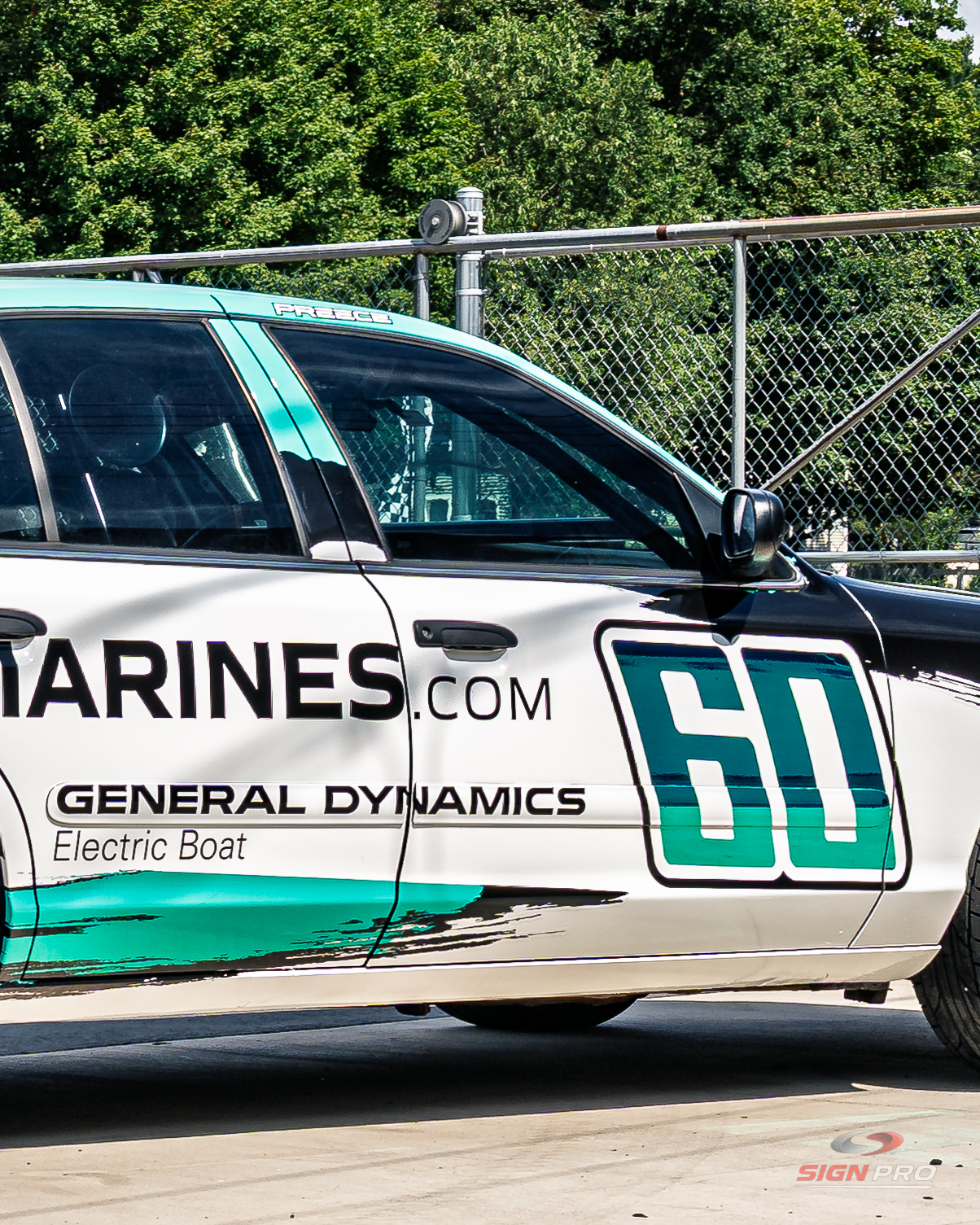 Custom race car wrap produced by Sign Pro featuring General Dynamics Electric Boat branding and sponsor graphics.