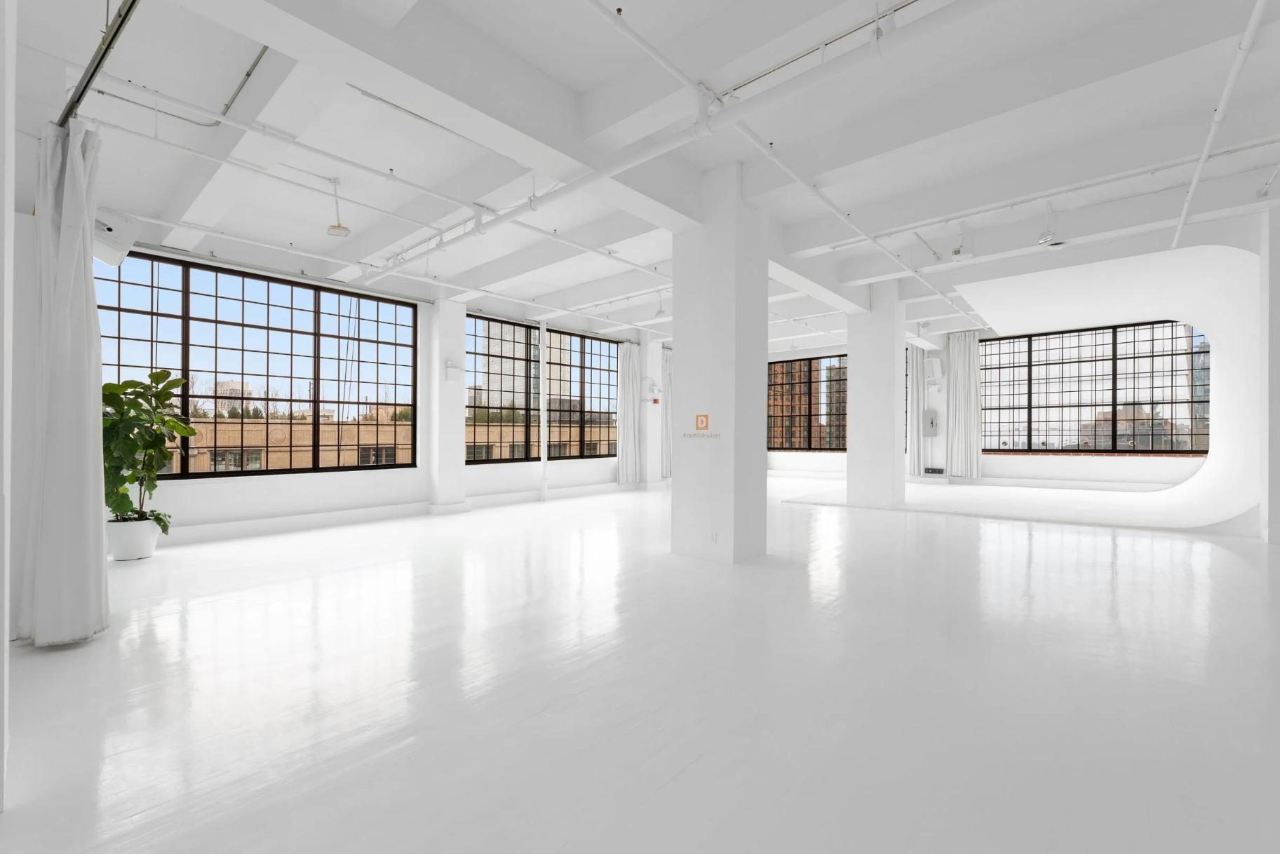 4,500 SF Studio 3, Venue Hudson Yards NYC, 22' cyclorama wall, factory sash windows, natural daylight, 15' ceiling, white floors, photo and video studio rental New York.