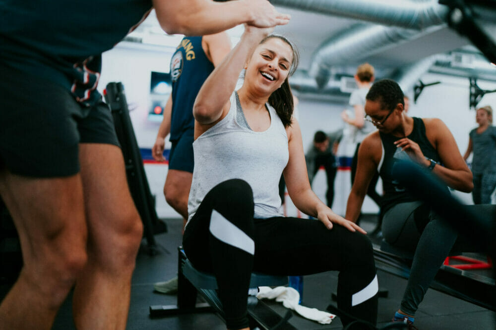Members completing a coached resistance exercise during an F45 class. 