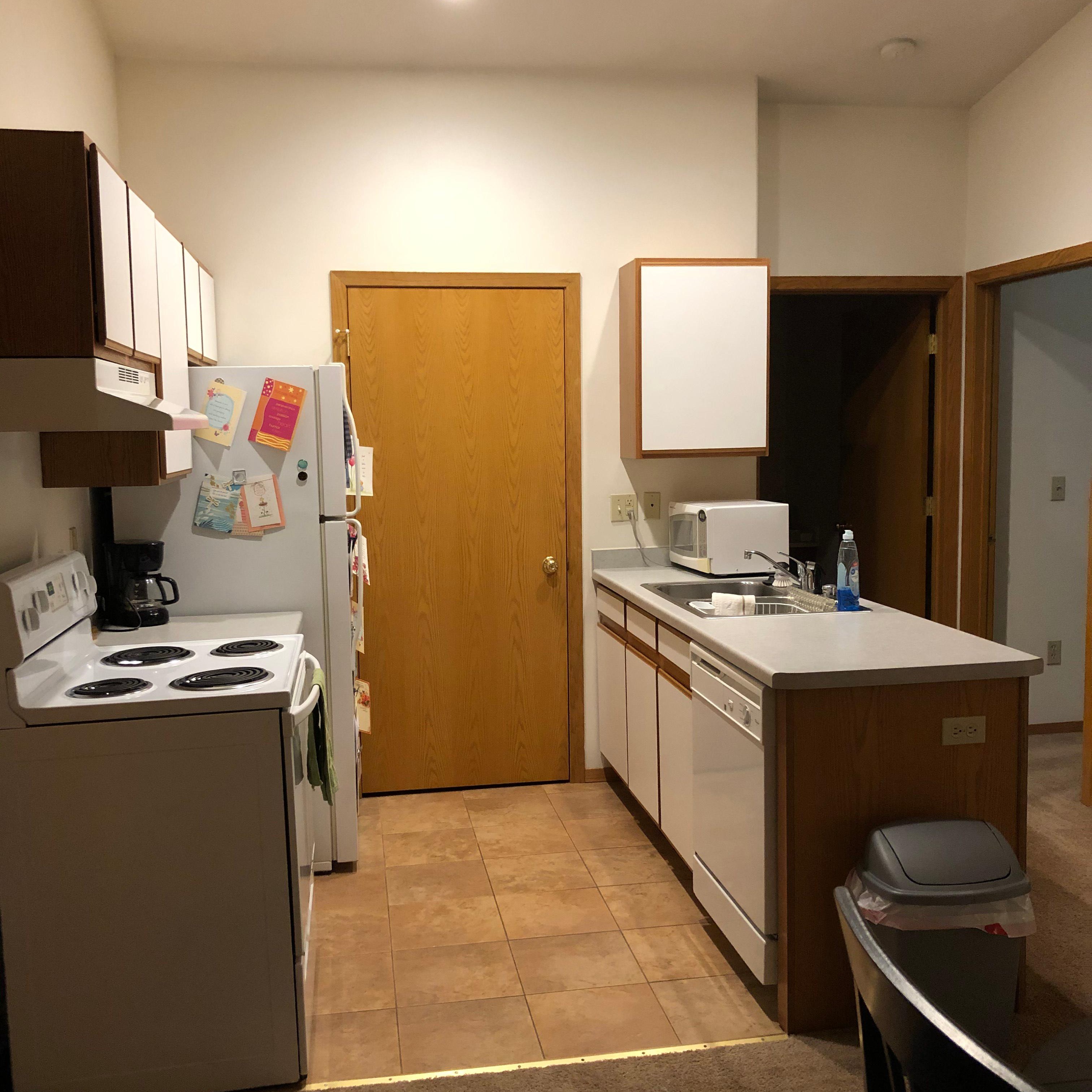 Woodsview Apartments Galley Kitchen with white cupboards