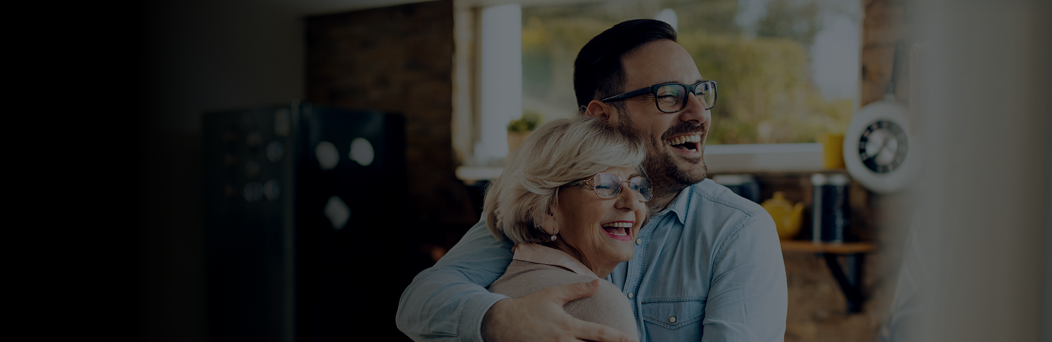 Adult son hugging senior mother.