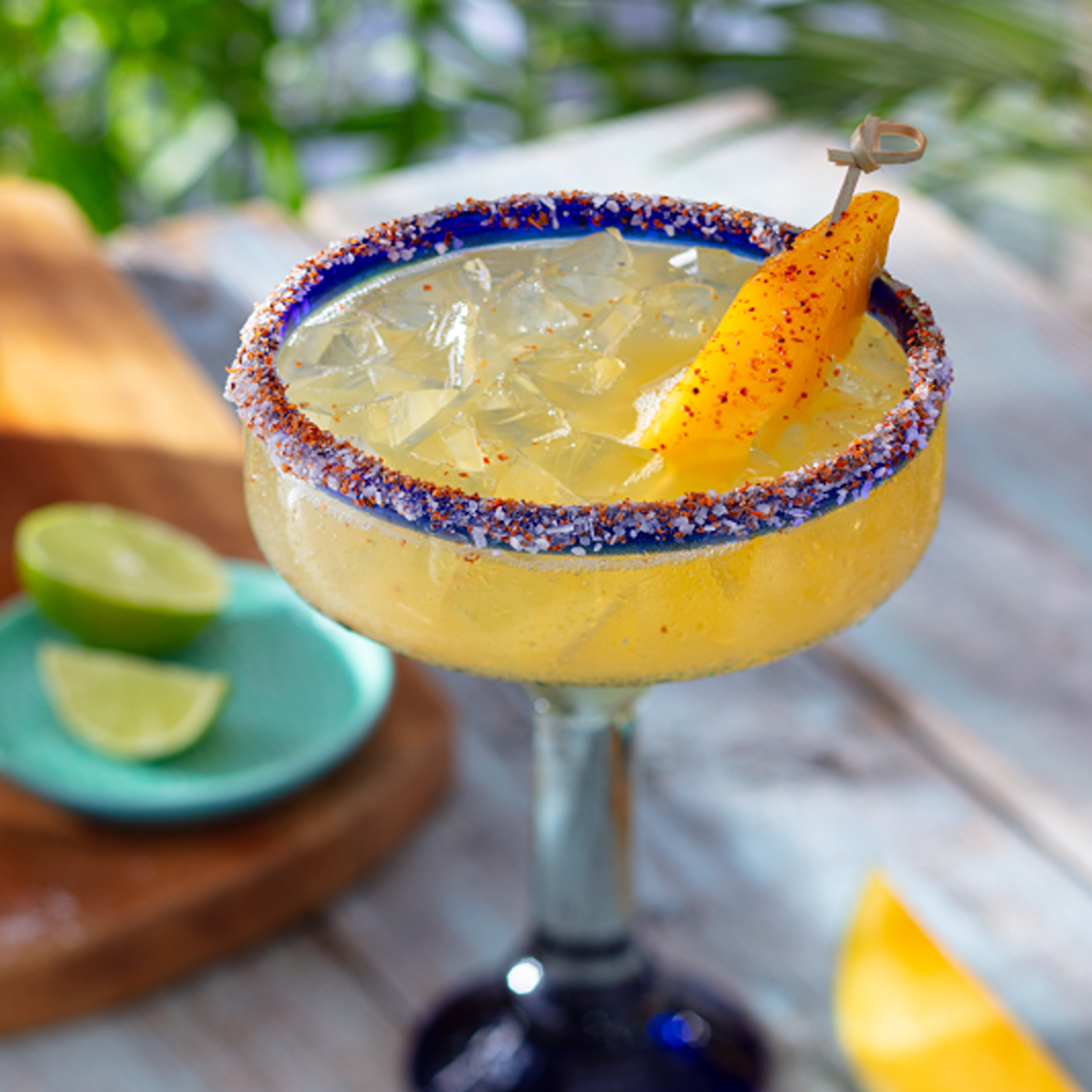 Hot Honey Mango Margarita - Casamigos Reposado Tequila, mango, hot honey and bitters with a sweet and spicy rim.
