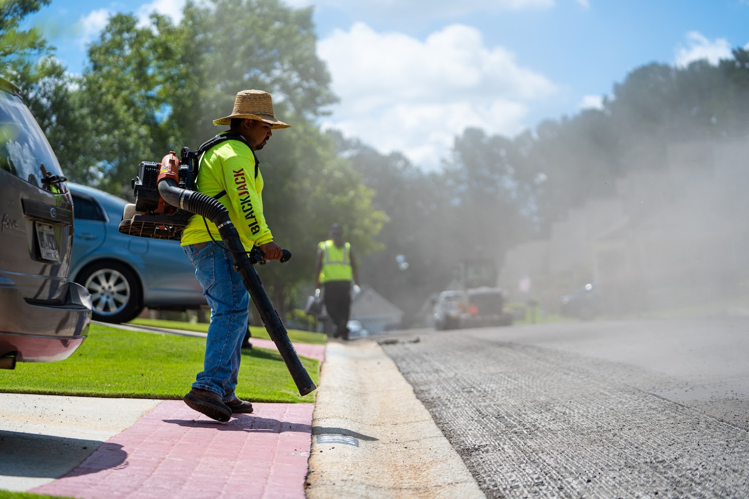 Crew cleaning up after street paving
