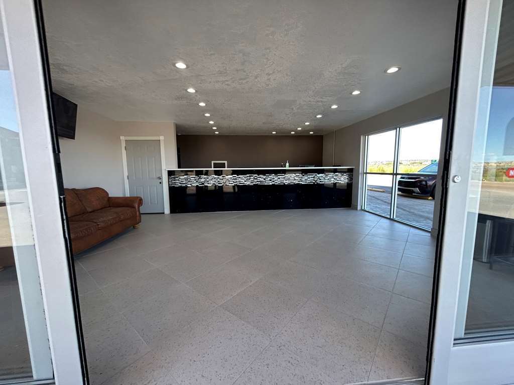 Looking at Front Desk and Lobby through front doors