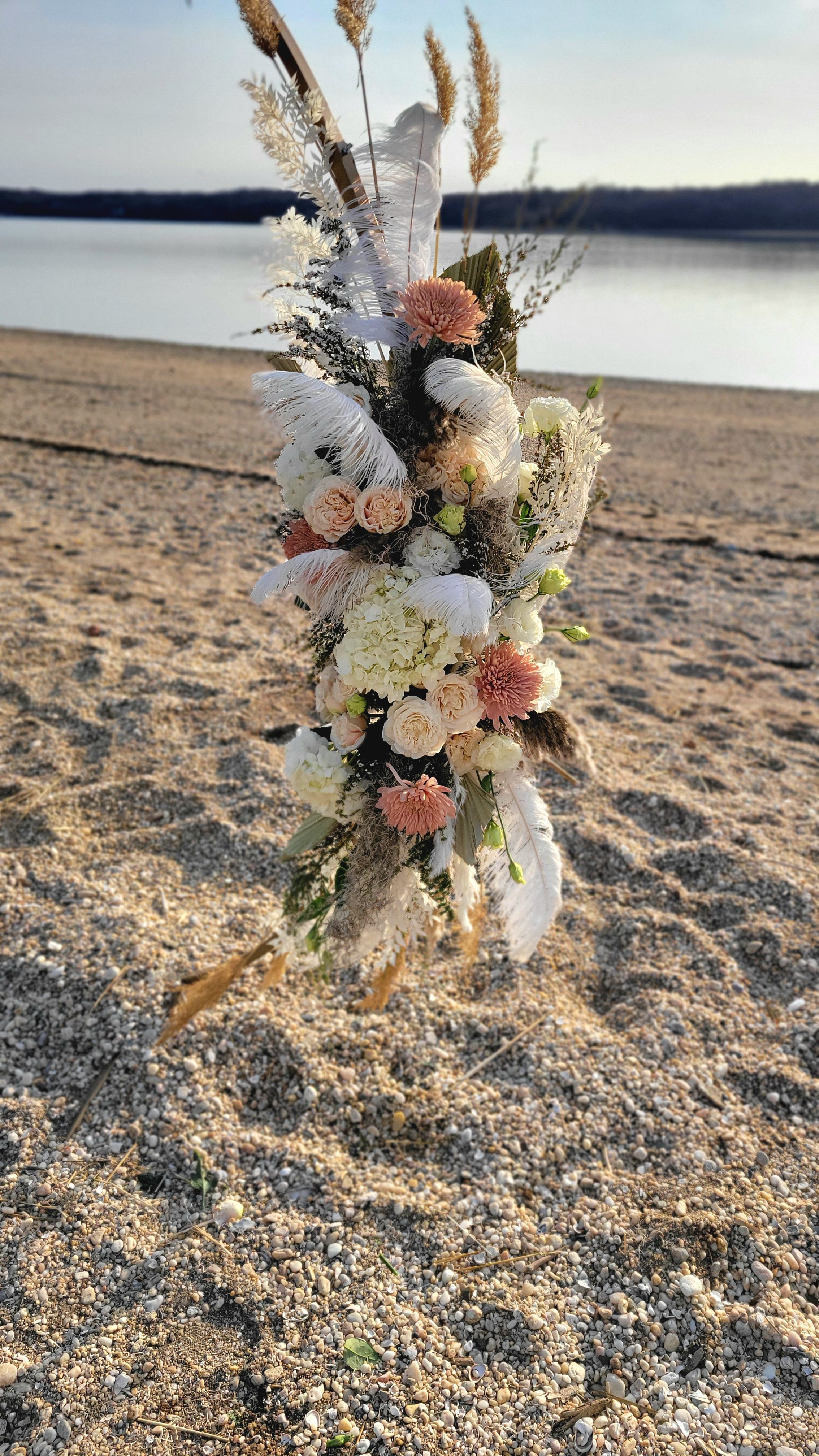 Boho wedding ceremony circle arch. West Neck Beach, Huntington NY. Neutral color palette with pampas grass, and ostrich feathers