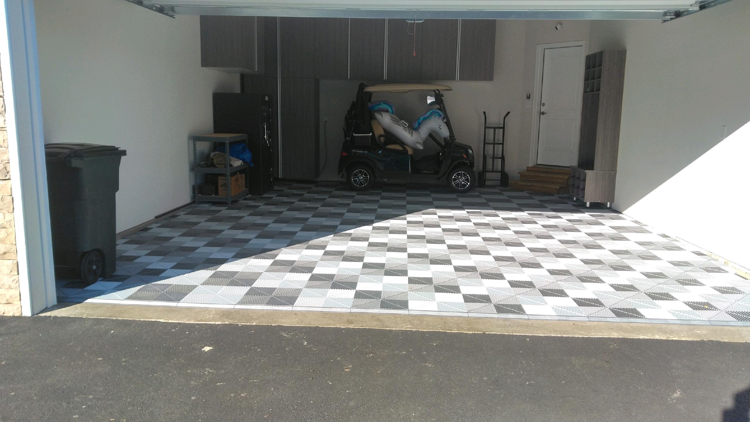 Custom SwissTrax floor with custom garage cabinets.  Complete with custom shoe cubbies, sitting area, and overhead storage for all your needs!