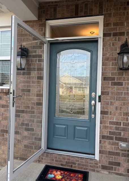 Decorative front entry door with glass sidelights installed by Highfield Door Sales