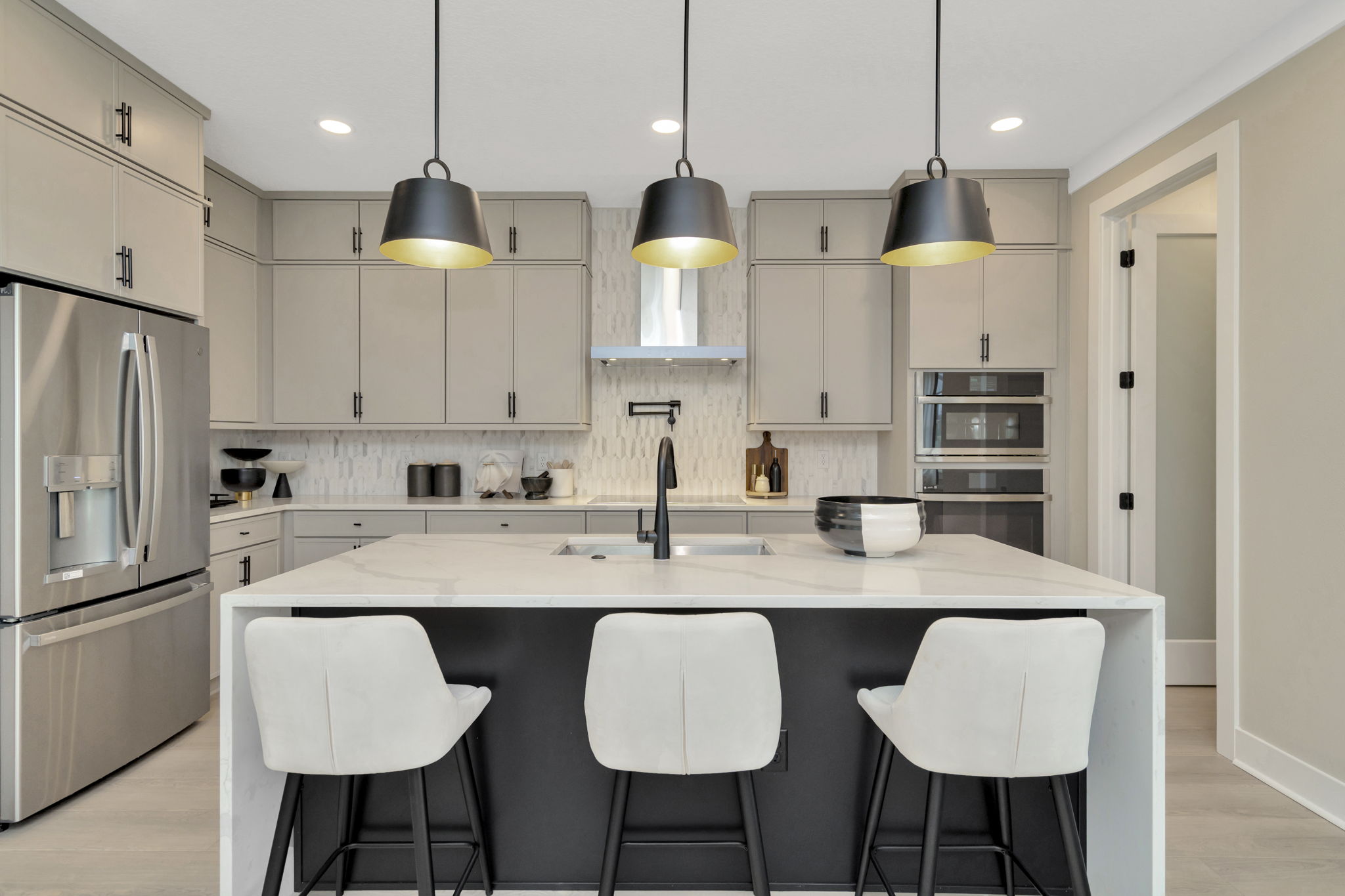 The Kitchen of DRB Homes Cocoplum Home Plan at Primrose at Longleaf in New Port Richey, FL.