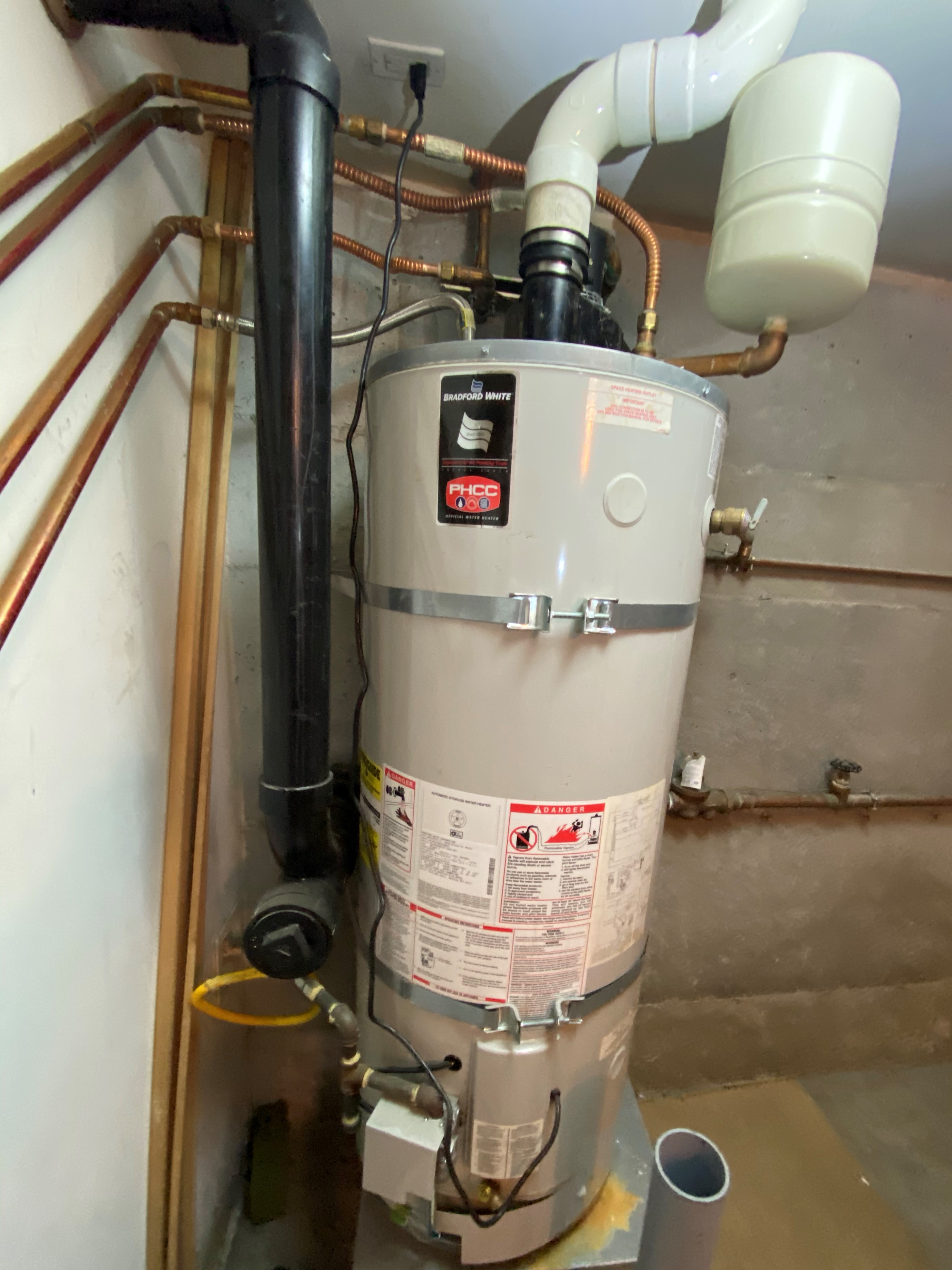 Power vent water heater installed on a residential property that is hooked up to the hydronic system as well as the domestic hot water.