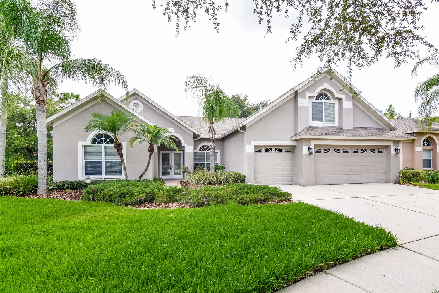 Front of home with three-car garage at Invitation Homes Tampa.