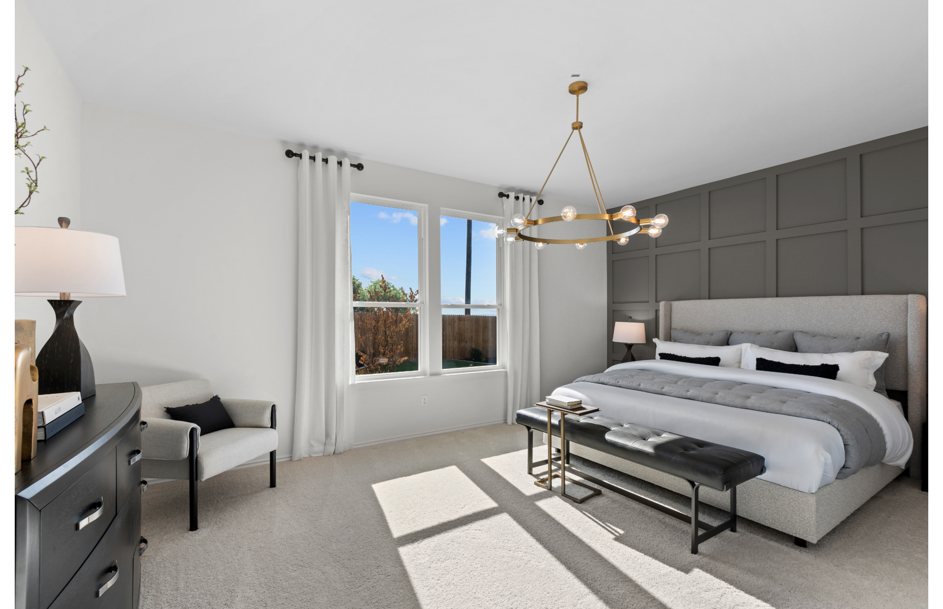 Large owner's suite with carpet and gray accent wall in new homes in Vista Real at Converse, TX