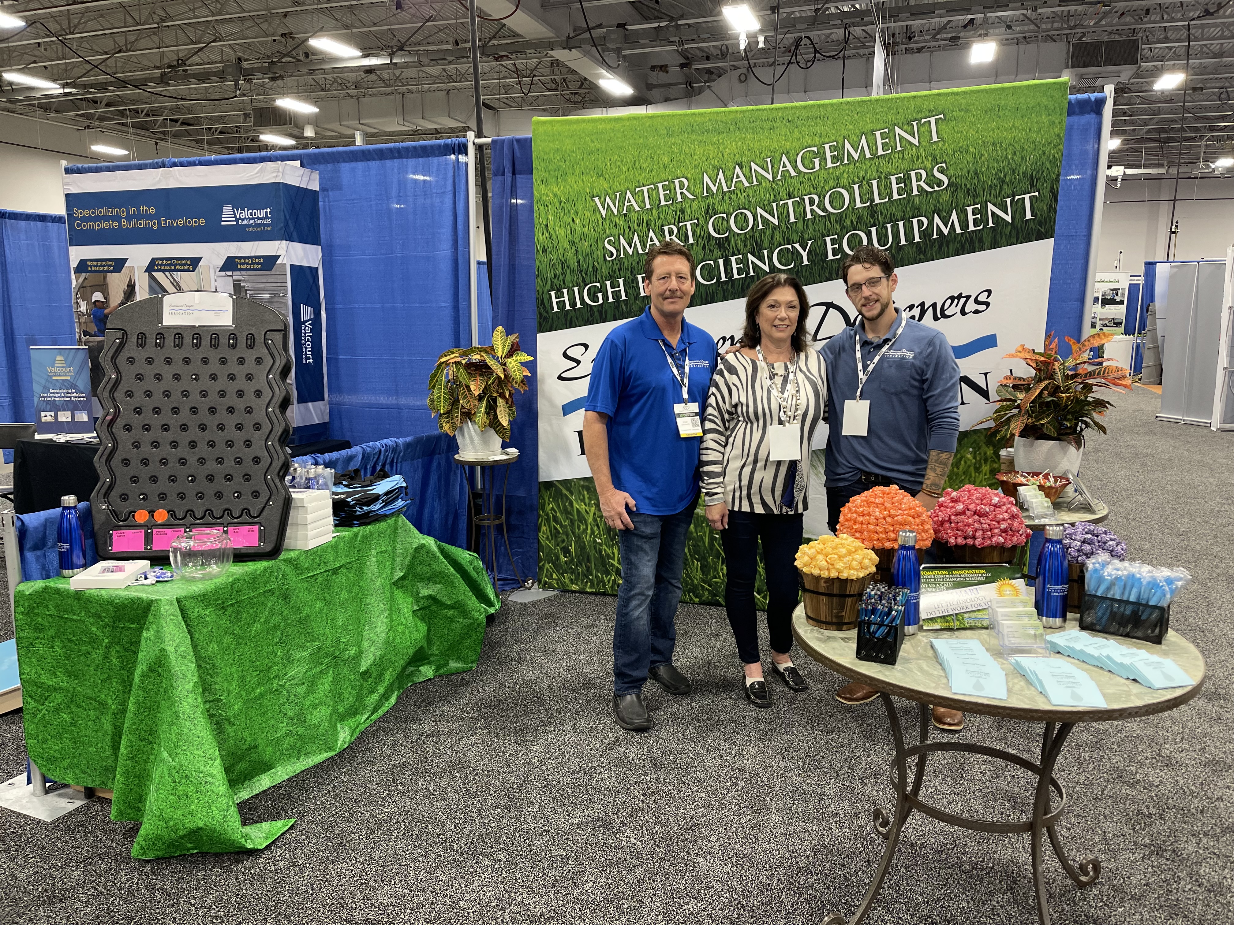 Environmental Designers Irrigation team members presenting company services at an industry trade show convention booth.