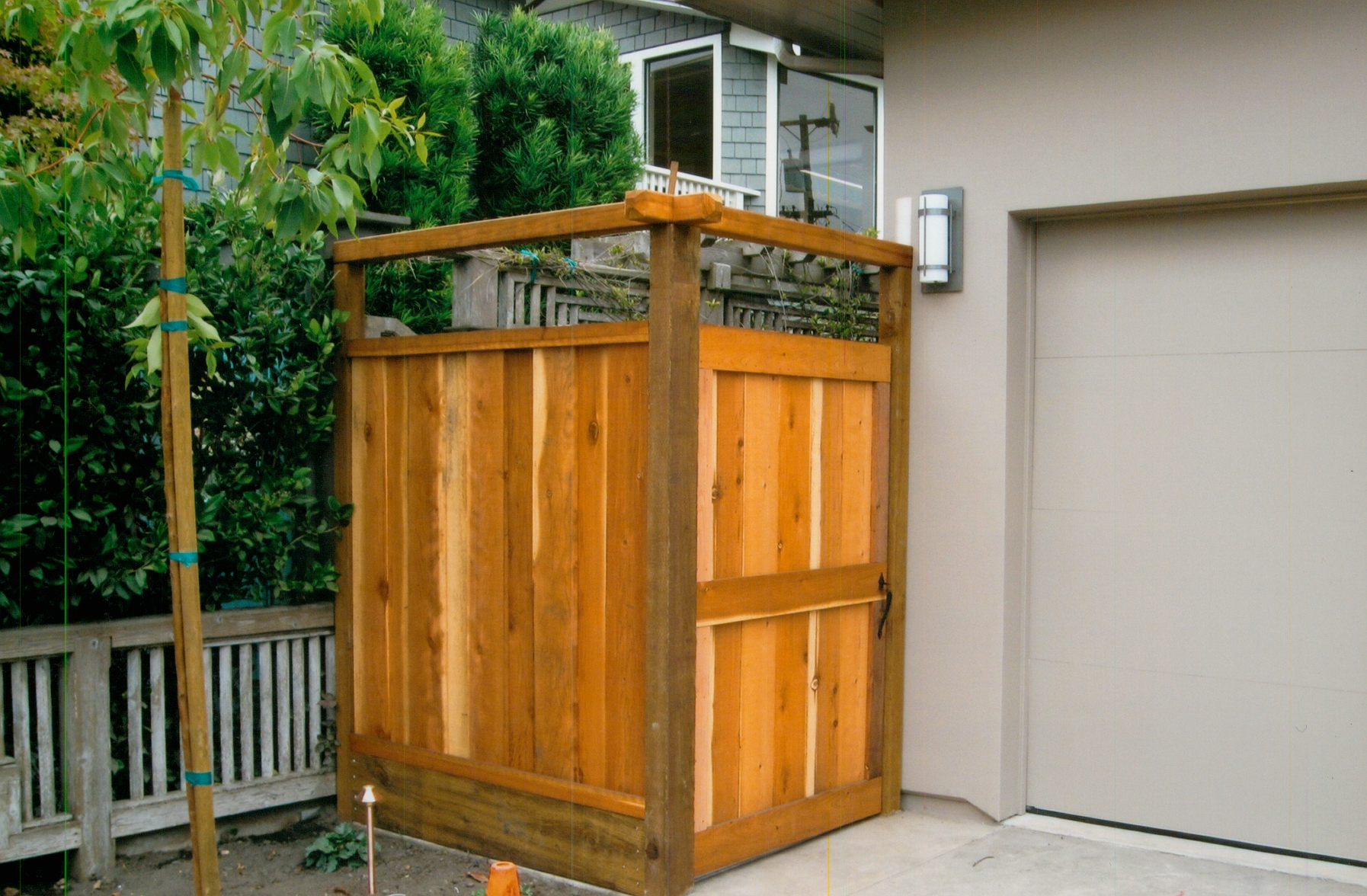 Custom wood gate and fence installation designed to provide privacy, security, and a polished entryway.