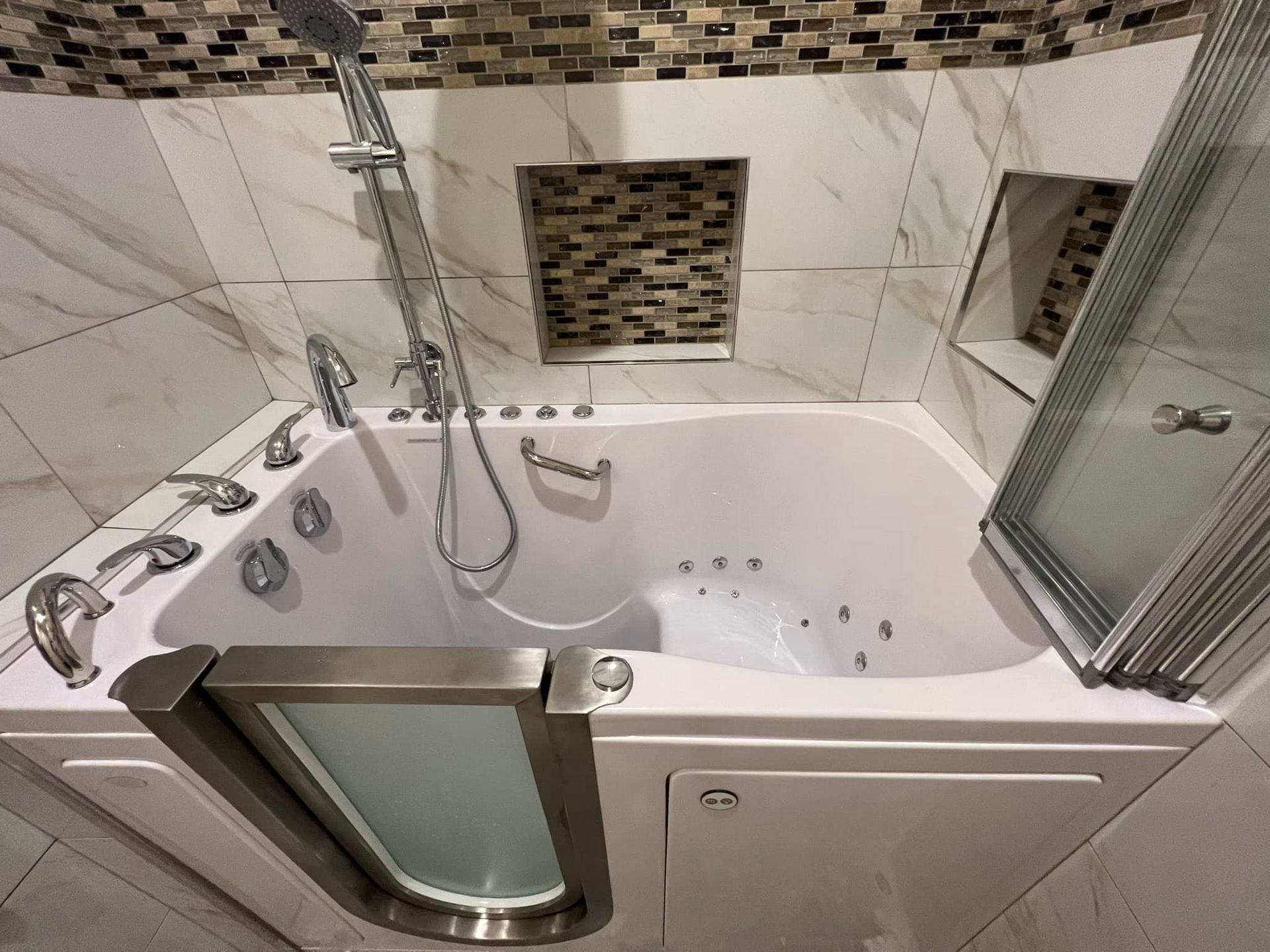 A spacious bathroom features a walk-in tub with multiple jets and a clear access door. The walls are 
