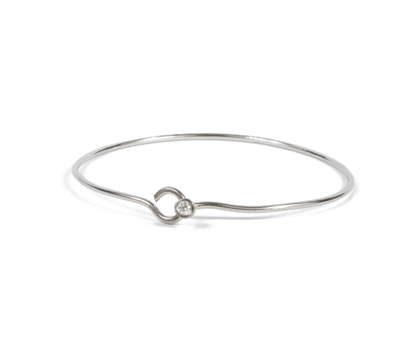 Elegant handmade silver bangle bracelet featuring a minimalist design with a sparkling gemstone accent. A timeless jewelry piece perfect for everyday wear, thoughtful gifting, holidays, birthdays, and special occasions.