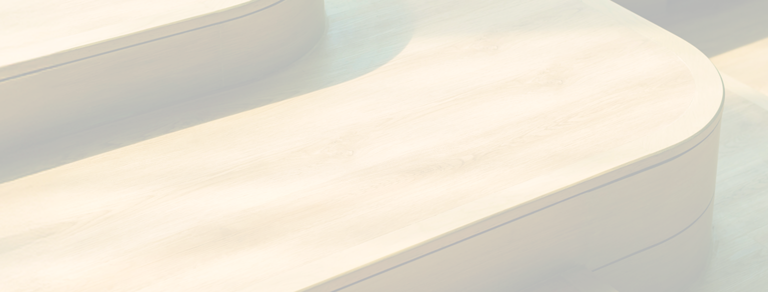 Dappled sunlight decorates wooden steps that have soft, curved edges.