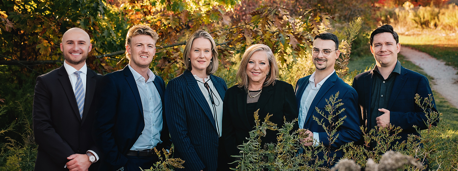 The Brenda Miller Family Wealth team posed outside among the multi-coloured autumn trees.