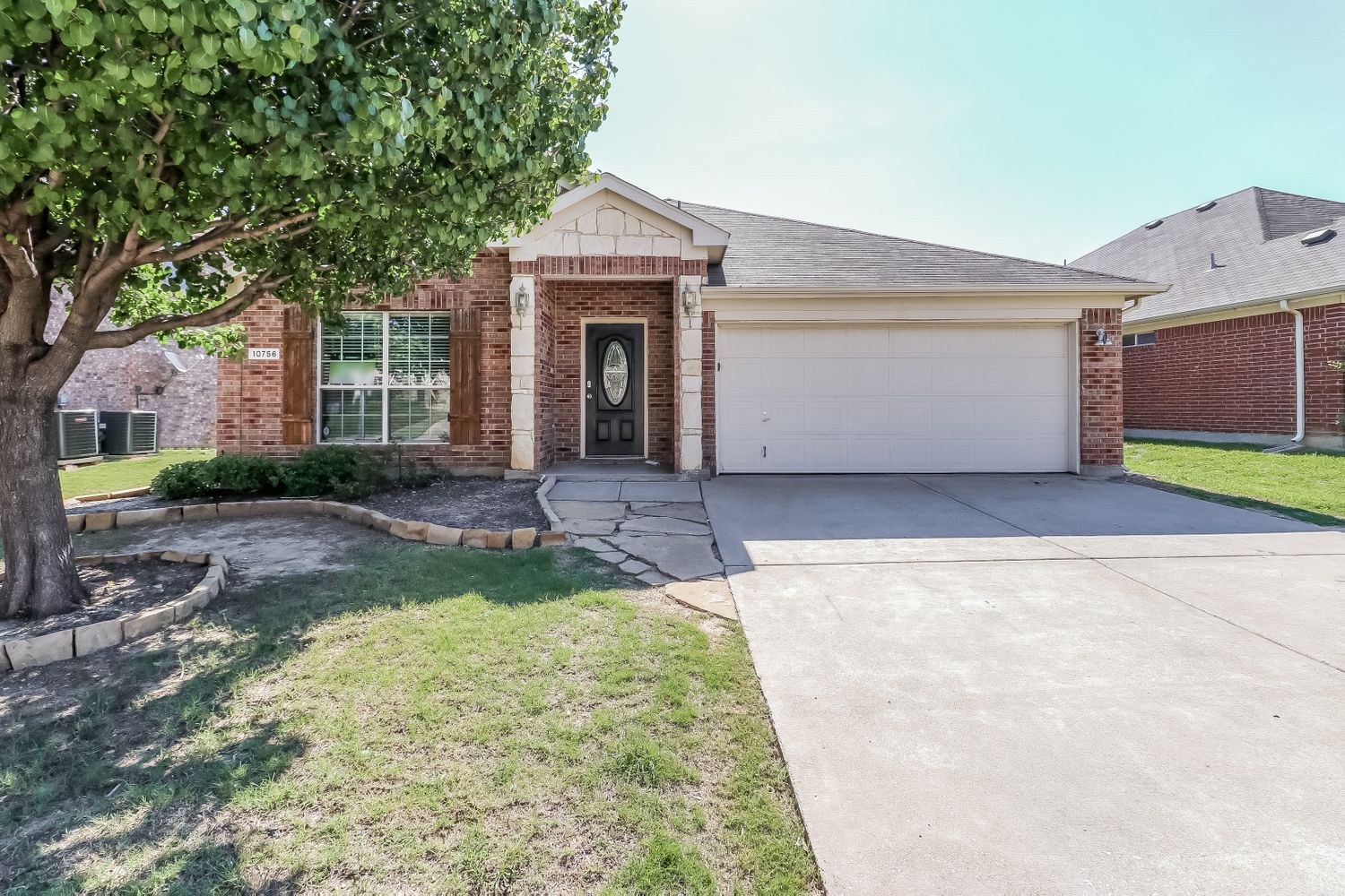 Front of home with two-car garage at Invitation Homes Dallas.