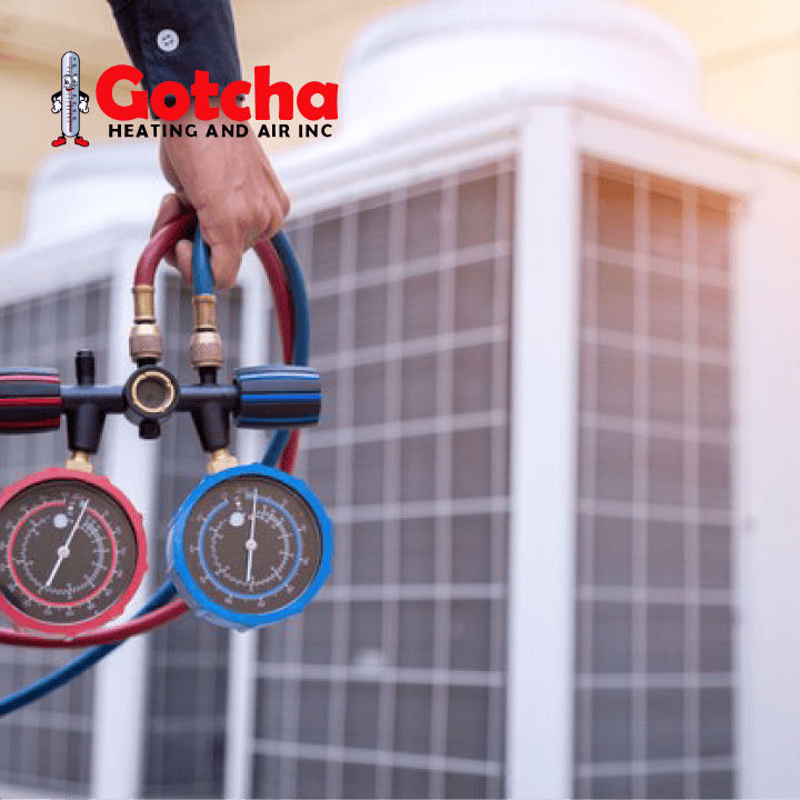 Licensed HVAC technician from Gotcha Heating and Air Inc servicing air conditioning unit with professional tools