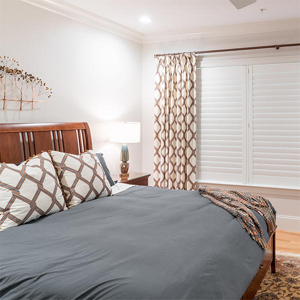 Curtain Drapery Panels paired with Shutters will bring style and class to any master bedroom! Our team at Budget Blinds of Rockwall, Terrell, and Greenville can help you design the perfect drapery/shutter duo for your unique style!