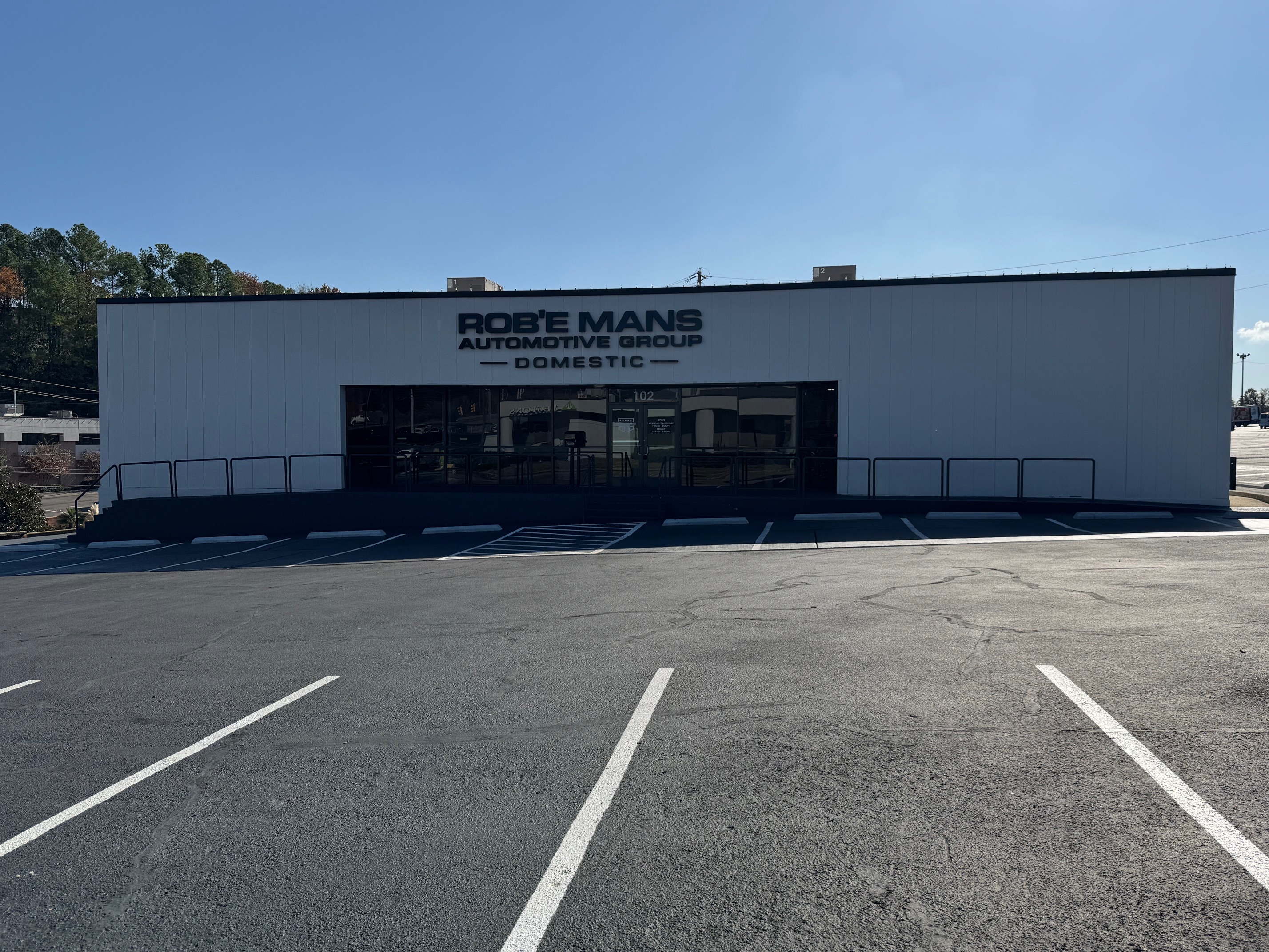 Front exterior view of Rob’e Mans Domestic Auto Repair, a trusted family-owned auto repair and maintenance facility serving Homewood, Birmingham, and surrounding Central Alabama communities since 1983. The building features professional automotive branding, multiple service bay doors, customer parking, and a clean modern exterior representing high-quality Domestic and American-made vehicle repair services. Rob’e Mans Domestic Auto Repair specializes in Ford, Chevrolet, GMC, Dodge, RAM, Jeep, Chrysler, Cadillac, and Buick repair including engine diagnostics, brake repair, transmission service, suspension repair, oil changes, tire services, and preventive maintenance performed by ASE-certified technicians.