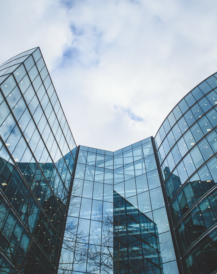 Upward view of a modern glass office building.
