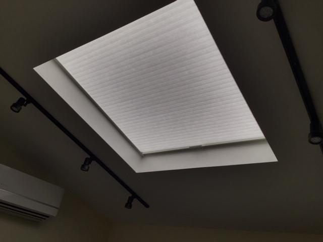 Regretting your skylight on ultra sunny days? Learn to love it again with a Light Filtering Skylight Honeycomb Shade like this one recently installed in Tarrytown, NY. Wondering how you open and close it? Don't worry—we thought of that. #BudgetBlindsOssining #TrilightHoneycombShades #ShadesOfBeauty