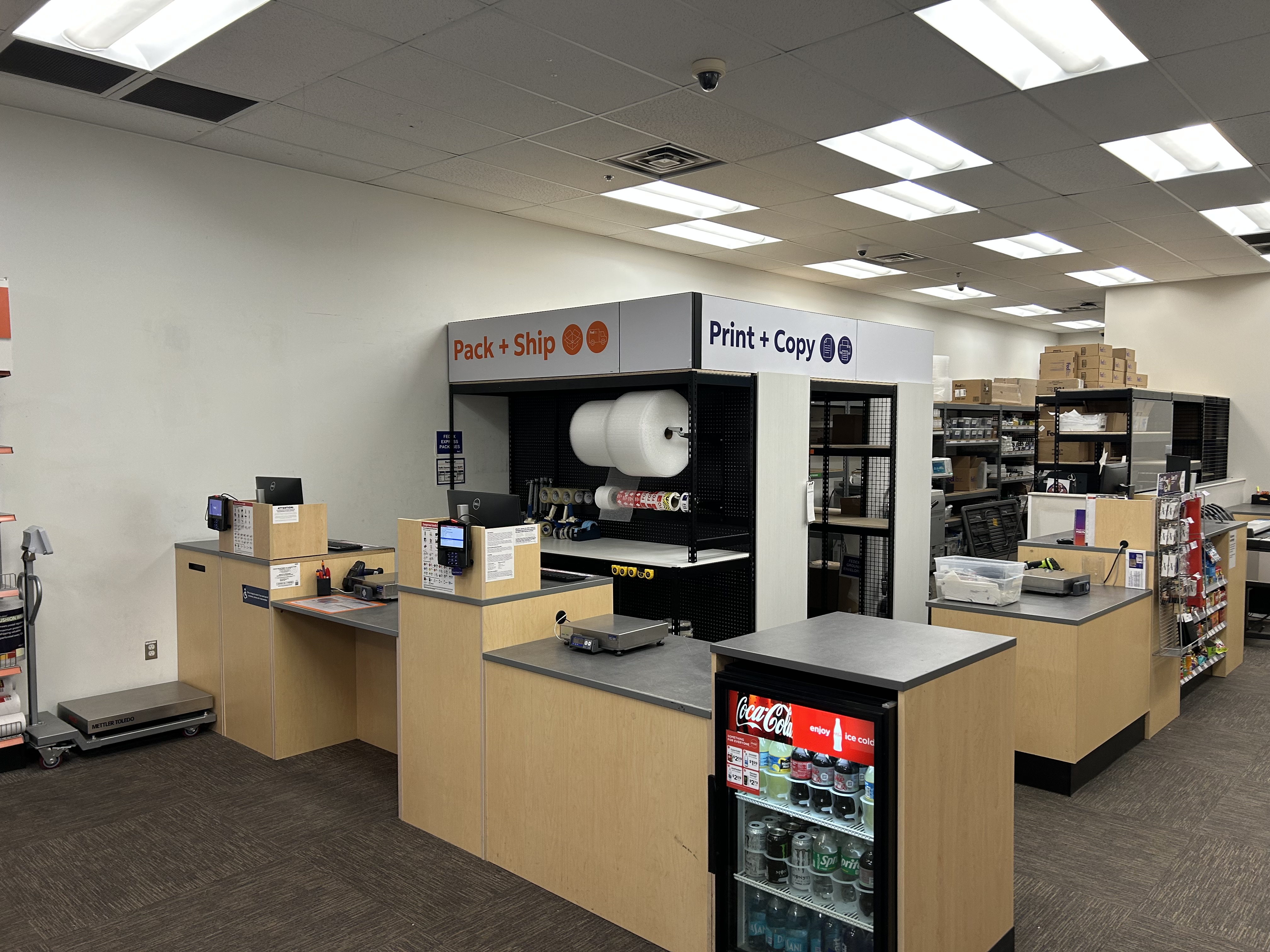 Print and Pack Service Counters &ndash; Combined print and shipping counters at FedEx Office Burleson Texas with workspace for customer orders and packaging.