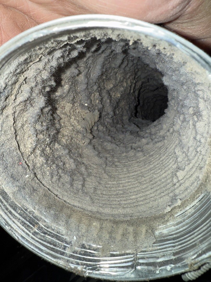 Before photo of a residential dryer vent heavily clogged with lint and debris. Upfront Home Inspection & Maintenance provides professional dryer vent cleaning services throughout Southern and Central Maine.