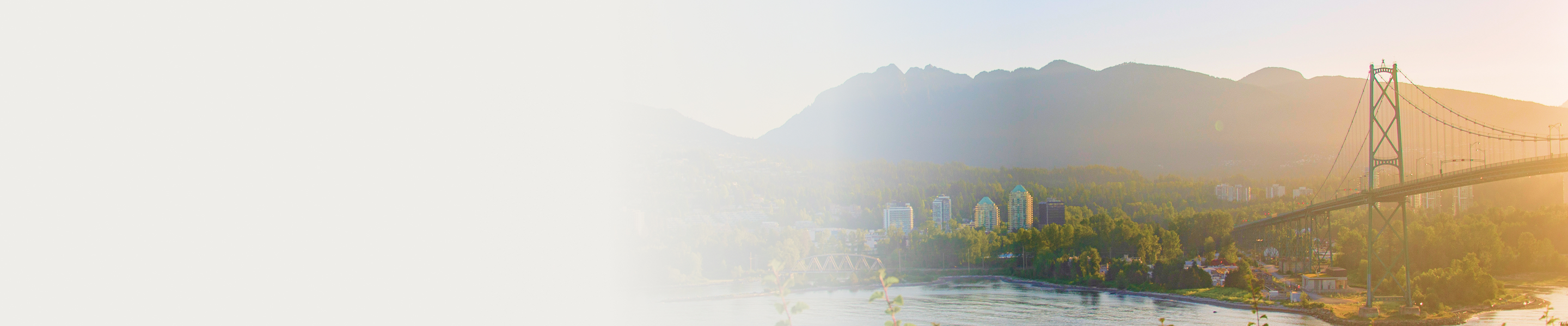 Suspension bridge in Vancouver with mountains in the background.