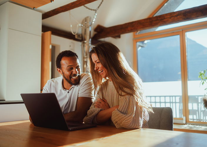 A couple reviewing their DS statements on their laptop.