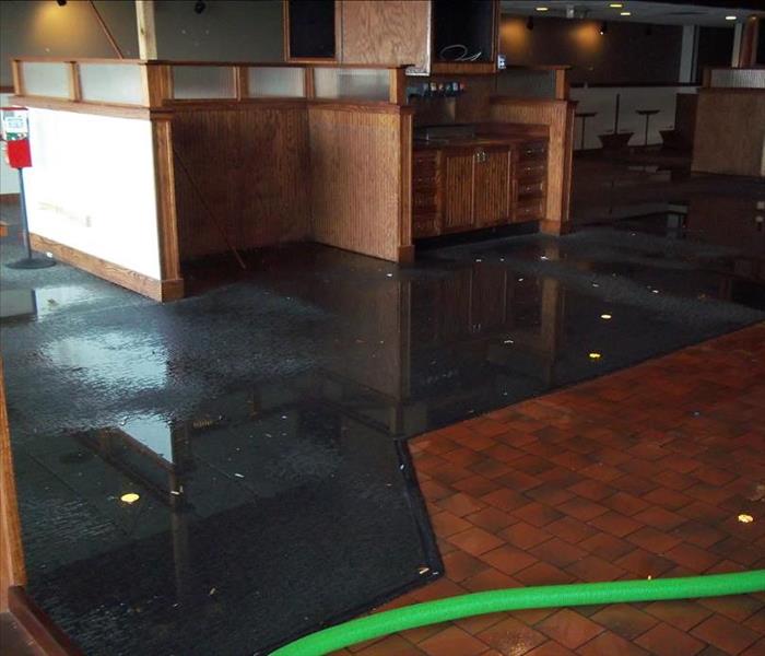 Storm damage affected this restaurant in Englewood. After major thunderstorms overnight the owners returned to find damage to the roof and water all over the floors. SERVPRO of Teaneck/Englewood arrived quickly. The licensed technicians removed all of the water and completely dried the area to prevent future damage.