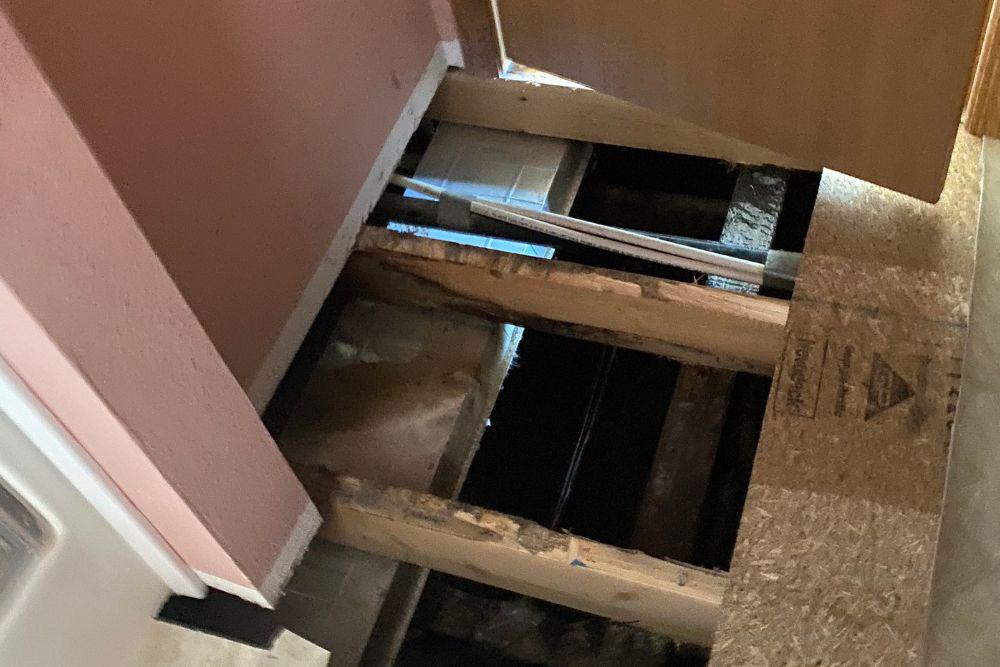 Pictured here is a ruptured frozen water pipe running below the kitchen subflooring on a Minneapolis water damage restoration project.