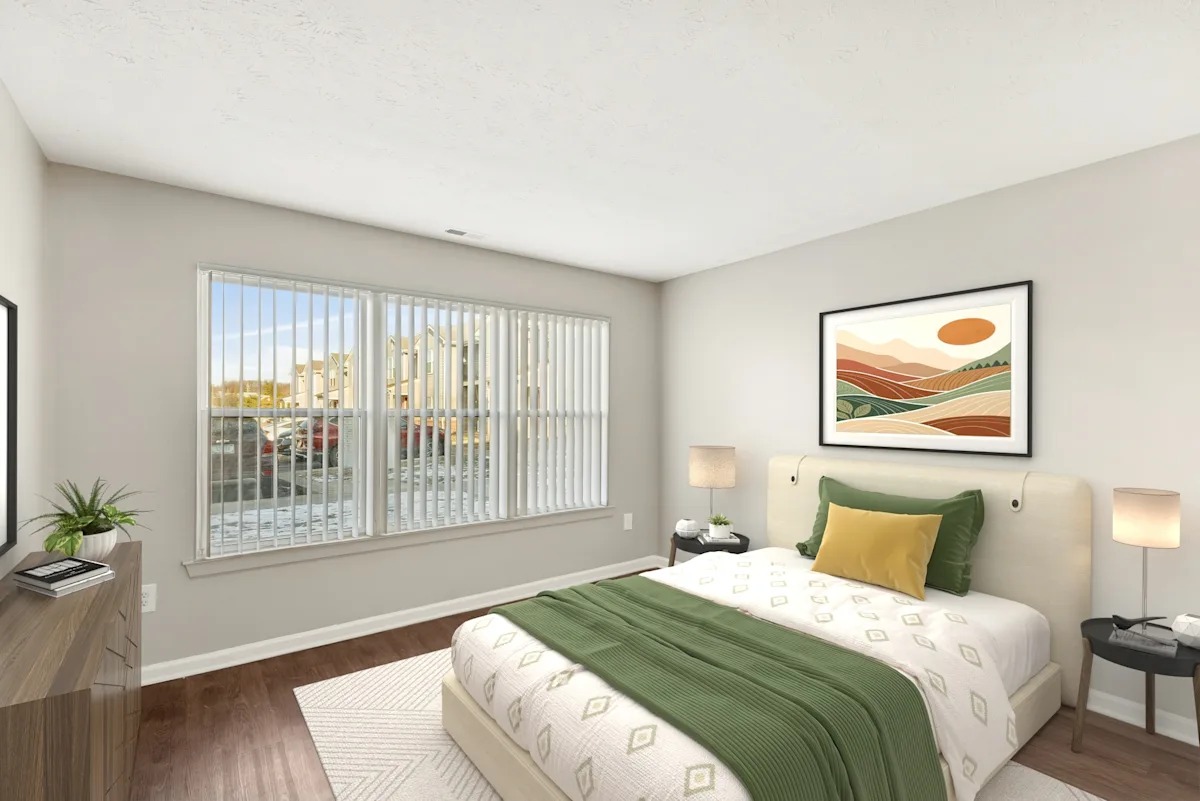 A bedroom with a painting on the wall