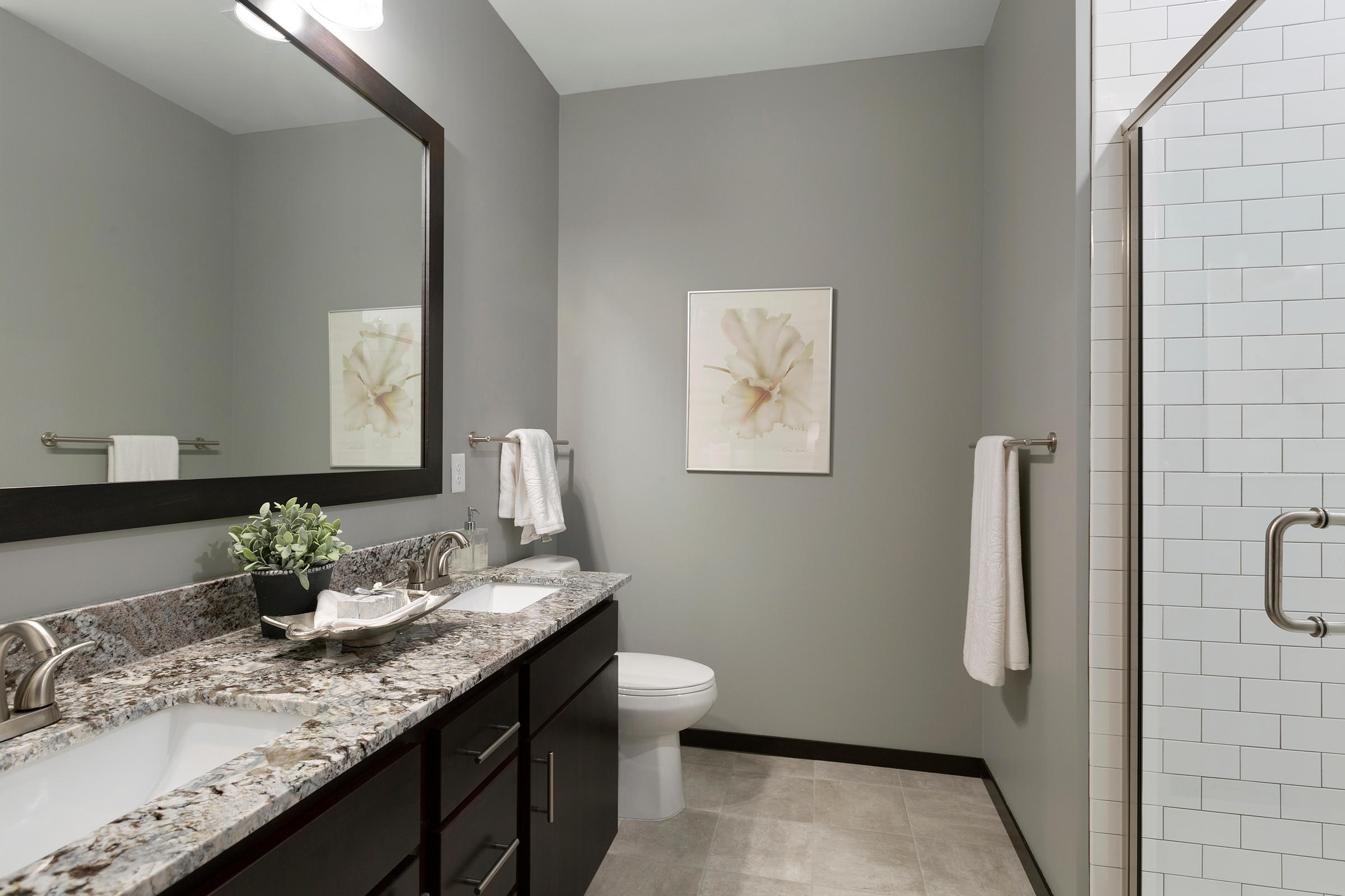 Bathroom With Dual Sinks, Granite Vanity & Tiled Walk-In Shower