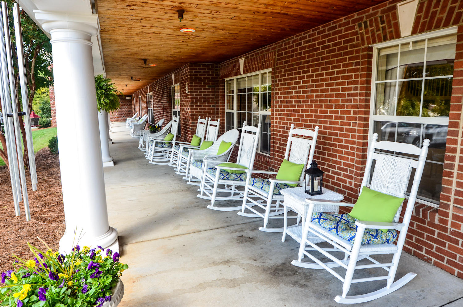 Legacy Heights Senior Living rocking chairs on covered porch